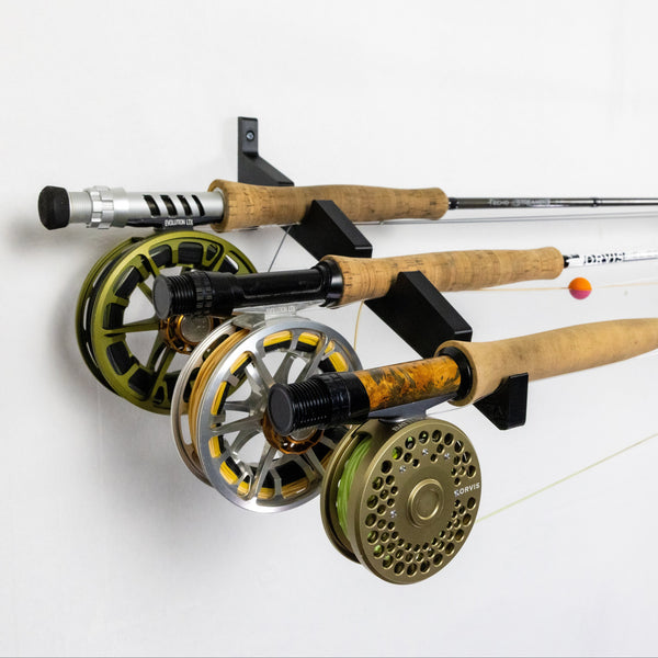 The Fishing Rod Holder Triple Wall by Pesca Innovations allows you to easily store three fully assembled fishing rods on a wall.