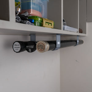 The Fly Rod Tube Holder Triple Shelf by Pesca Innovations can hold any three fishing rod tubes under a shelf.