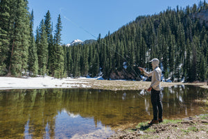 Pesca Innovations founder Nikolai fly fishing on a snow-lined mountain river in Colorado