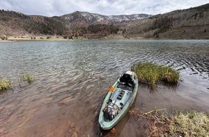 Organized kayak fishing gear setup on a Colorado mountain lake with rod holder and tackle storage