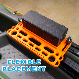 Orange and black tool holder on a kayak with 'FLEXIBLE PLACEMENT' text.
