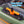 Orange and black cleat on a green kayak with 'Multiple Colors' text above.