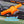 Orange cleat with flexible placement text on a green background