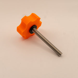 Orange plastic knob with a threaded metal shaft on a beige background