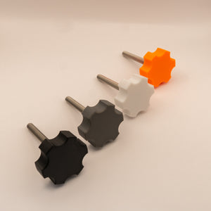 One knob in black, white, gray, and orange on a beige background