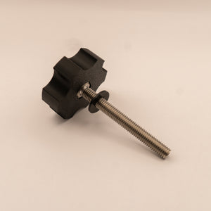 Black knob with a threaded rod on a beige background