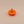Orange plastic knob with a metal screw on a beige background