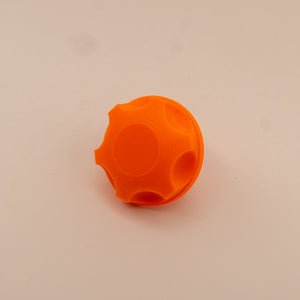 Orange plastic mounting knob on a beige background