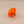Orange plastic knob on a beige background