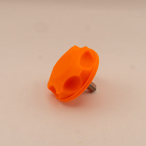 Orange plastic knob on a beige background