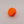 Orange plastic knob on a gray background