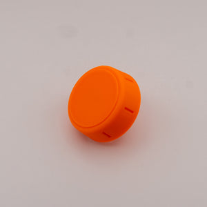 Orange plastic knob on a gray background