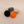 Four knobs in black, gray, orange, and white on a beige background