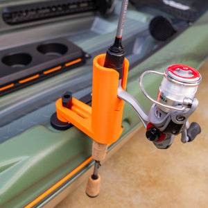Fishing rod and reel holder attached to a kayak's side with a fishing rod holder.