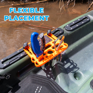 Orange kayak tool holder and magnet pad on a green kayak with water in the background