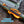 Orange and black T-track anchor system attached to a green kayak on water.
