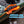 Orange anchor line locking loop on a kayak with water in the background