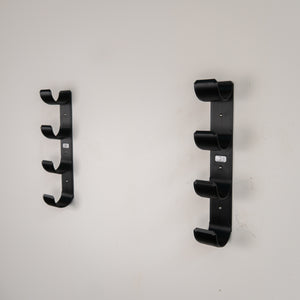 Fly rod tube holder quad wall mounted on wall with no tubes.