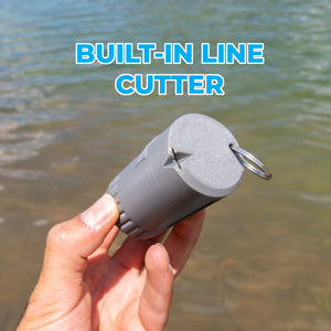 A hand holding a gray cylindrical line waste holder and cutter with a metal keyring, set against a background of shallow water, with the text 'BUILT-IN LINE CUTTER' at the top.