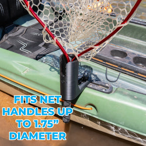 A close-up of a black kayak-mounted net holder clamped onto the side of a green kayak, with a fishing net attached. Large blue text reads 'FITS NET HANDLES UP TO 1.75"'
