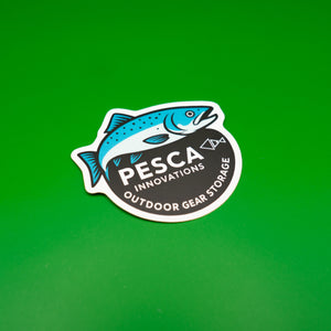 Sticker with a silver salmon fish design and 'PESCA Innovations Outdoor Gear Storage' text on a green background