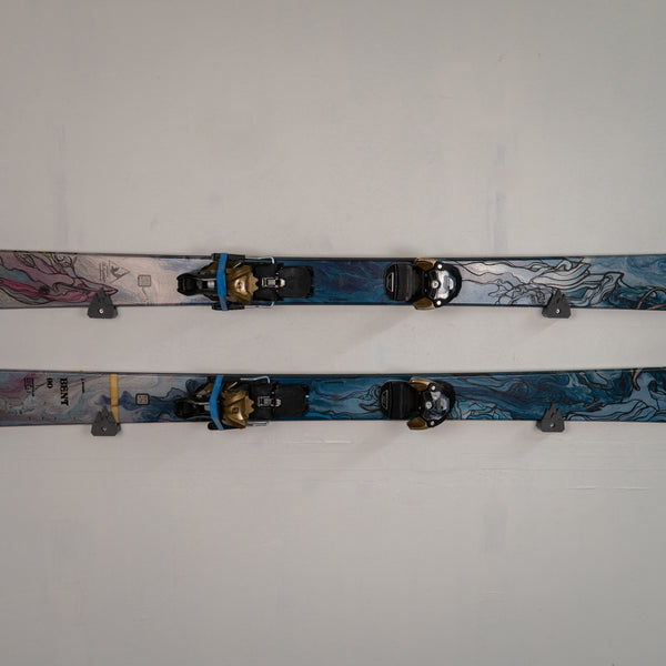 Two pairs of skis with bindings on a white background