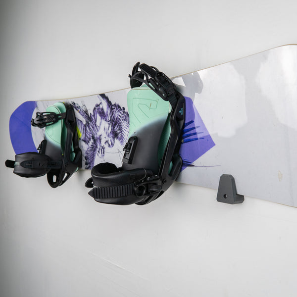 Snowboard with bindings attached on a white background