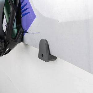 Gray plastic bracket on a white surface with a white background