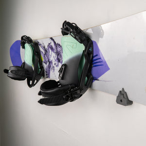 Snowboard with bindings on a white surface