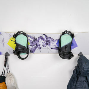 Snowboard with bindings on a white surface