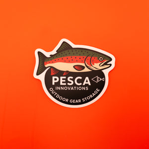 Sticker with a rainbow trout fish design and 'PESCA INNOVATIONS' text on an orange background
