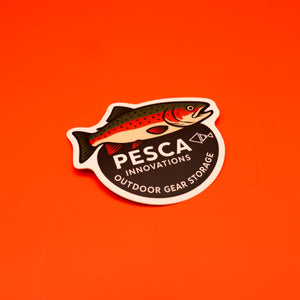 Sticker with a rainbow trout fish design and 'PESCA INNOVATIONS' text on an orange background