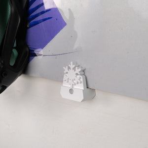 Plastic snowflake-shaped mount on a white surface with a blurred background