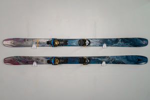 Pair of skis with bindings on a gray background