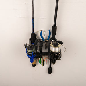 Fishing rod holder with two fishing rods and reels on a white wall.