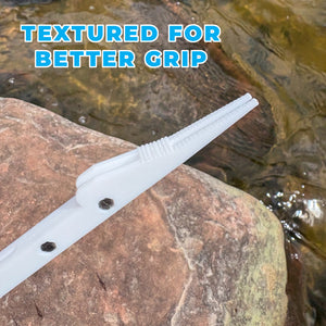 White textured knot tool shown outdoors on a rock with water in the background, with the text 'TEXTURED FOR BETTER GRIP' overlaid at the top.