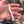 Hand holding a white tool with a blurred background