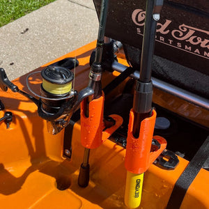 Orange fishing rod holder with one fishing net and one fishing rod in it 