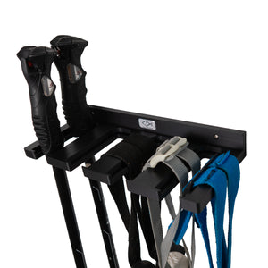 Black ski pole holder by Pesca Innovations with ski poles hanging by the straps and by the handle.