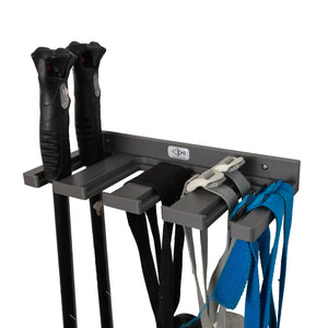 Gray ski pole holder by Pesca Innovations with ski poles hanging by the straps and by the handle.