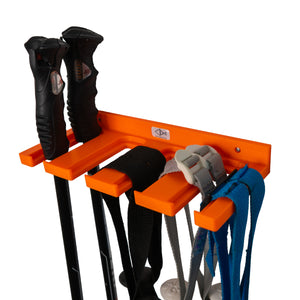 Orange ski pole holder by Pesca Innovations with ski poles hanging by the straps and by the handle.