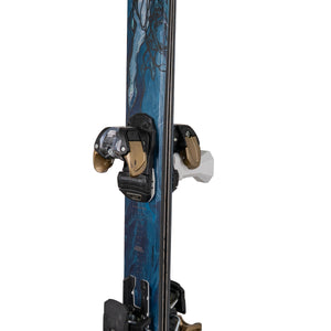 White vertical ski hanger by Pesca Innovations with gold and blue ski hanging by binding on a white background.