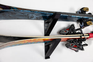 Image of both Ski Holder Attachments in Use. Skis sit aligned with each other and clear of obstructions for easy removal and storage. 