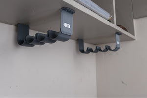 The Fly Rod Tube Holder Quad Shelf by Pesca Innovations can hold four fishing rod tubes under any shelf. 