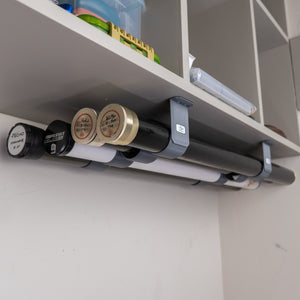 The Fly Rod Tube Holder Quad Shelf by Pesca Innovations can hold any four fly rod tubes under a shelf.