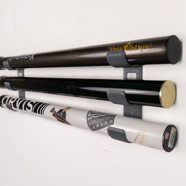 The Pesca Innovations Fly Rod Tube Holder Triple Wall can store three fishing rod tubes on a wall. 