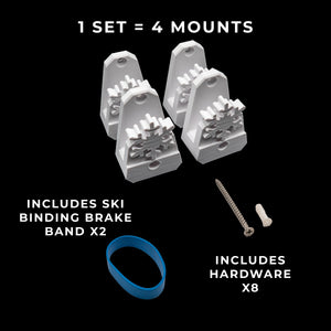 Set of ski binding mounts with hardware on a black background