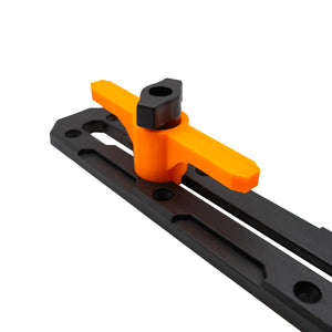 Orange and black kayak cleat on a black T-rail with white background